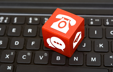 Contact Us icons on Red Dice on top of keyboard Customer serviceの写真素材