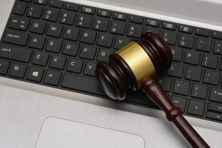 Online Auction wooden Gavel on computer keyboard