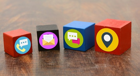 Contact Us Means Icons on wooden blocks.