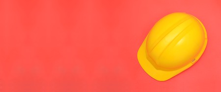 Yellow safety helmet on pink banner template.の写真素材