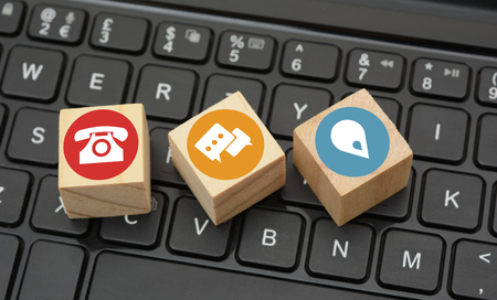 Contact Icons on black keyboard wood dices.の写真素材