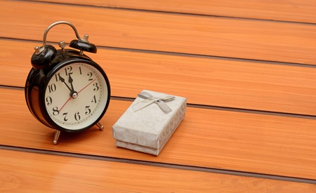 Alarm clock with gift box, reminder concept background