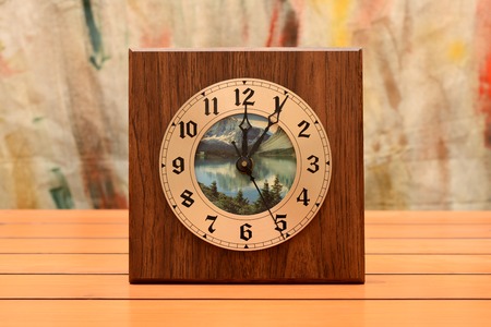 Wooden wall clock on table, time concept