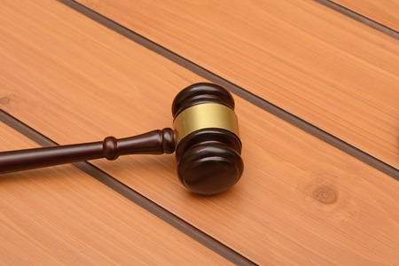Wooden Gavel on table, law related background