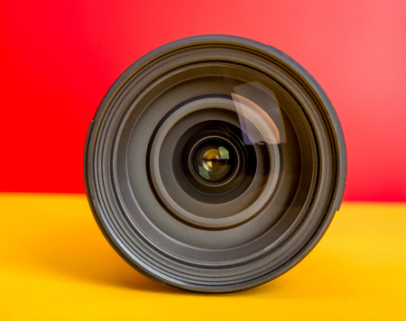Professional Camera Lens on red and yellow background templateの写真素材