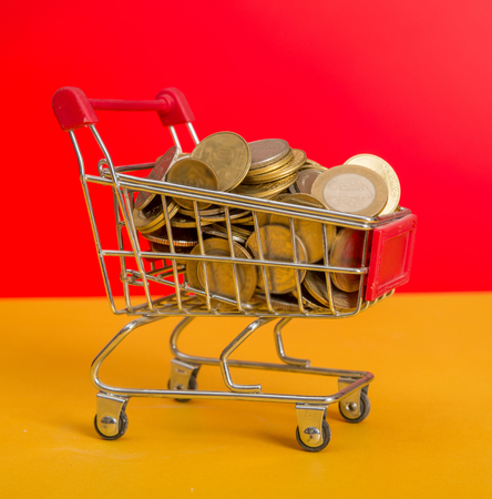Coins loaded on shopping cart market themeの写真素材
