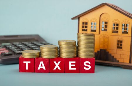 Increase in property taxes concept visualised with coins stackの写真素材