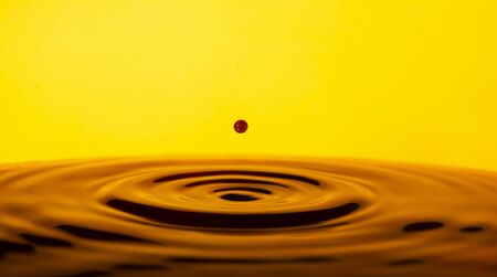 Colorful paint splash stock photo with yellow background, abstract backgroundの写真素材