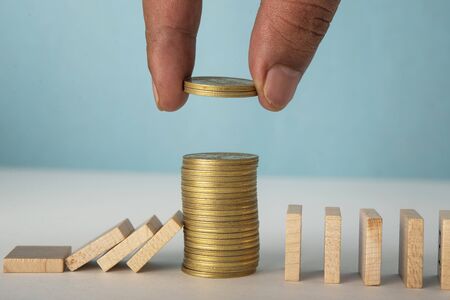 Financial support business concept with Coin Stack and wooden blocksの写真素材