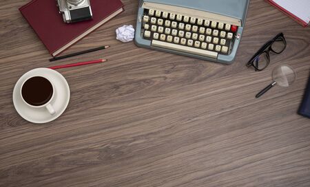 Typewriter on the old wooden desk with coffee cupの写真素材