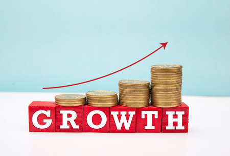 Text of growth on wooden box with coins, business Grow conceptの写真素材