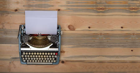 Vintage typewriter with wooden banner background