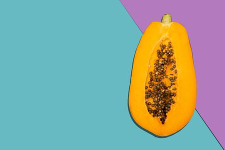Close up photo of papaya on multi color background with copy spaceの写真素材