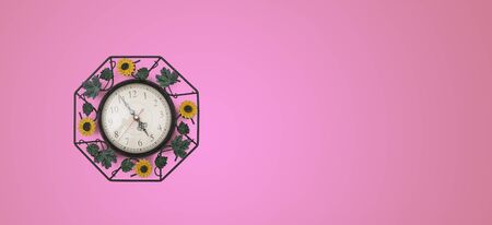 Close up clock set on pink background, time concept with copy space