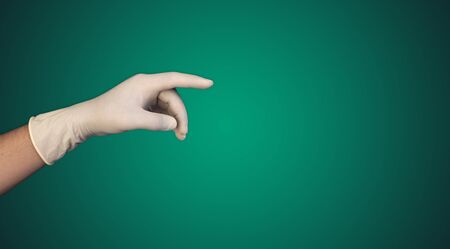 Doctor hand with glove pointing towards with copy space for your text.の写真素材