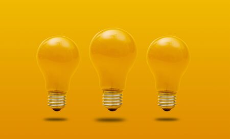 Idea concept with light bulbs on a yellow background with copy space for your test.の写真素材
