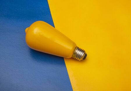 A close up of a yellow light with yellow and blue backgroundの写真素材