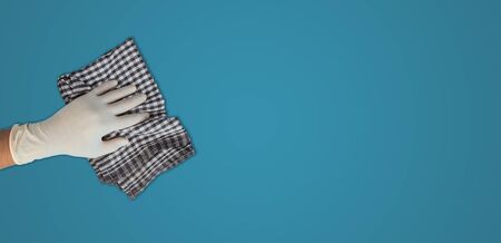 Close up view of young man wearing cleaning with cloth, corona virus conceptの写真素材