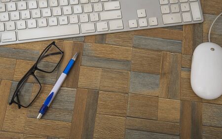 Modern working place on wood table with computer mouse and keyboard