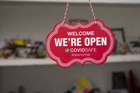 Welcome we are open sign in front of a shop after covid-19 pandemic