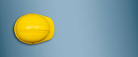 Yellow safety helmet on blue banner template with copy space.
