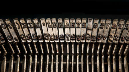 Closeup view of vintage typewriter keys in revers with visible ink.