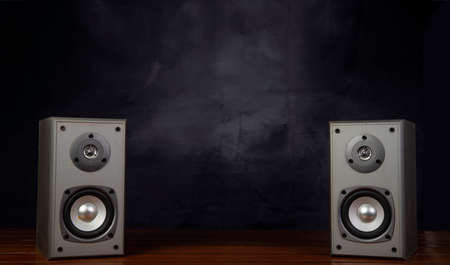 Two audio speakers with smoky background music related banner.