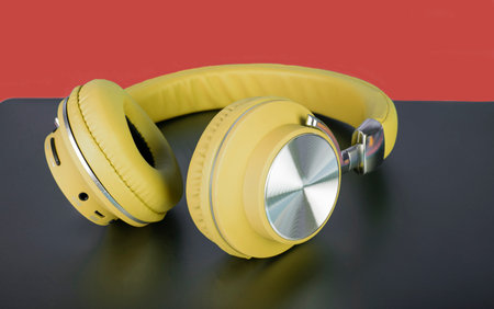 Yellow color wireless headphone closeup concept of music and exercise.の写真素材