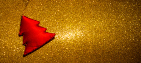 Red Fabric Christmas tree on yellow glitter background theme.の写真素材