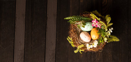 Easter Eggs in nest on wooden table.