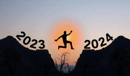 Silhouette of a man jumping over the gap between the year 2023 and 2024.