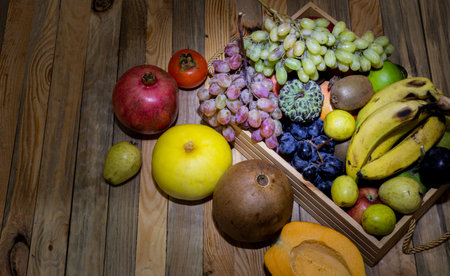 Basket of organic fruits on wooden banner background - fresh eating concept.