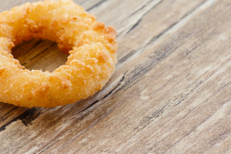 Fried Onion Ring on Wood Tableの写真素材