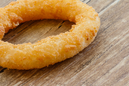 Fried Onion Ring on Wood Tableの写真素材
