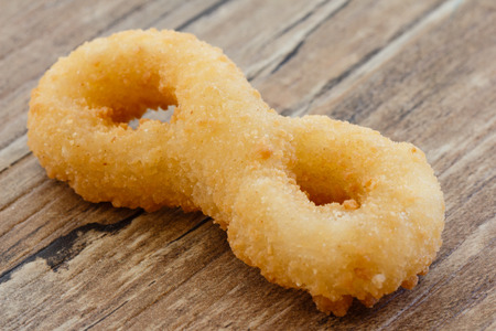 Fried Onion Ring on Wood Tableの写真素材