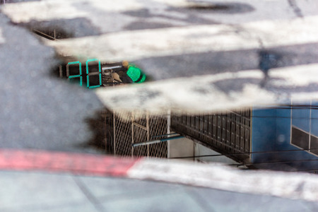 Crosswalk after raining with stop-and-go lightの写真素材