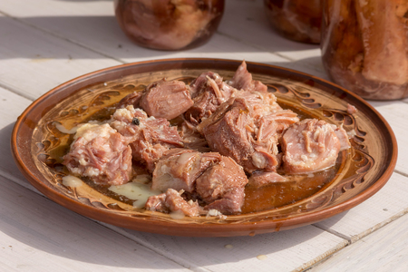 pieces of stew on a clay plate. Traditional cuisine. Daylight. Close viewの写真素材