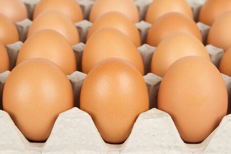 Background of brown eggs in box