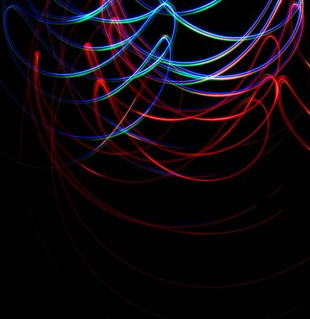 Chaotic colorful lights on black backgroundの写真素材