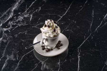 A cup of con panna on marble table stock photo
