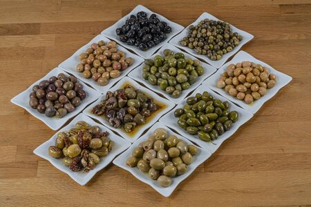 Olives assortment in bowl with oil.