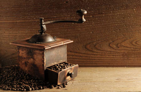 Roasted coffee beans are ground in a coffee grinder.の写真素材