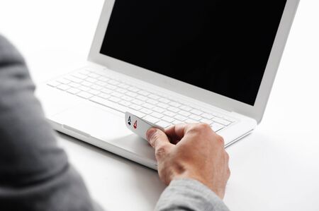 poker online, poker cards on white laptop - concept photoの写真素材