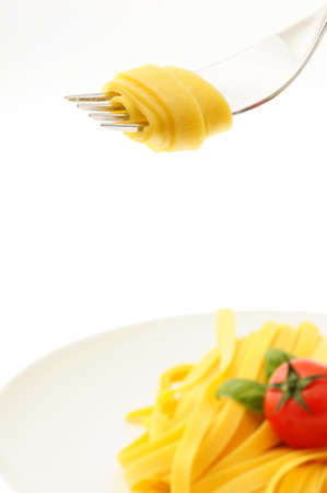 Rolled spaghetti on a forkの写真素材