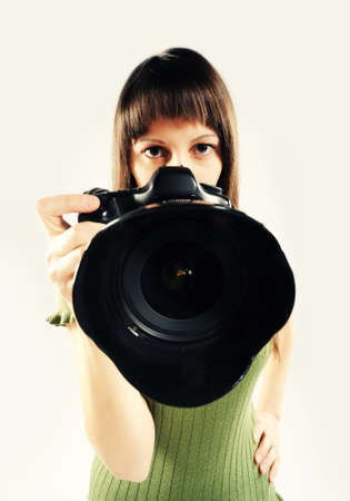 Woman taking a photo with a digital SLR camera with a digital SLR camerasimilar photographer...