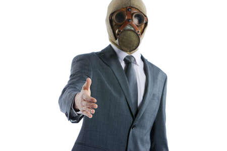 portrait of businessman in a gas mask offering for handshakeの写真素材