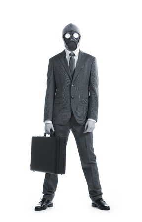 portrait of businessman in a gas mask  with suitcaseの写真素材