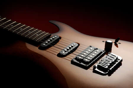  close up of a electric guitar on dark backgroundの写真素材
