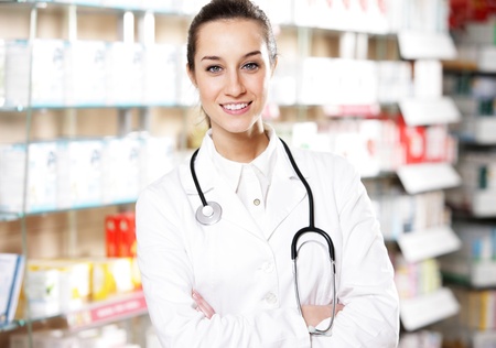 portrait of  smiling young woman pharmacist with stethoscopeの写真素材