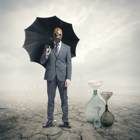 Global Warming:Businessman waiting for the rainの写真素材